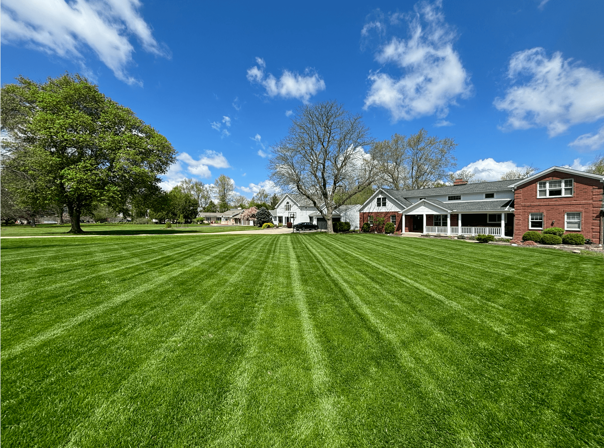 Professional lawn mowing with striped patterns